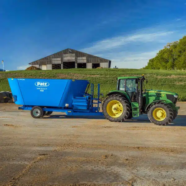 Patz tractor trailer TMR vertical mixer on a farm.