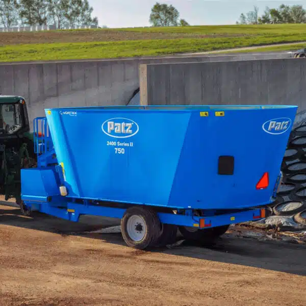 A Patz trailer TMR vertical mixer inside a silage bunker.