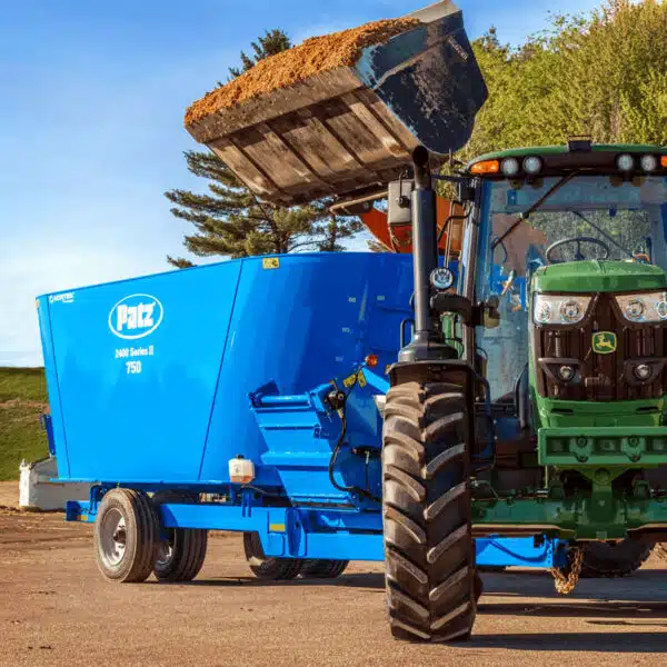 A Patz TMR mixer being filled with silage.