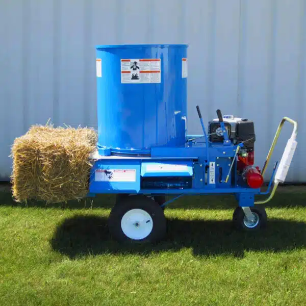 Patz bedding chopper blower with a hay bale on the back. Model 9427 with blower end facing camera.
